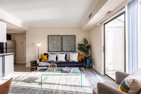 a living room with a couch and a glass coffee table